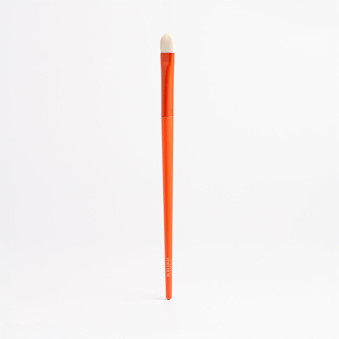 Flat Eye Shadow vegan makeup Brush with white bristles and an orange handle and is perfect for packing on colours or shimmers and doubles as a great tool for concealer application.