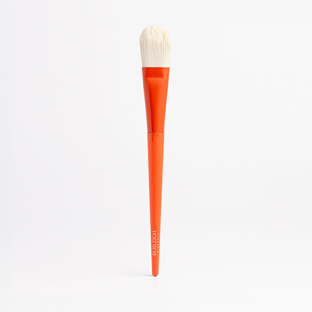 Foundation vegan makeup Brush with white bristles and an orange handle ensures controlled application of liquid and cream foundation