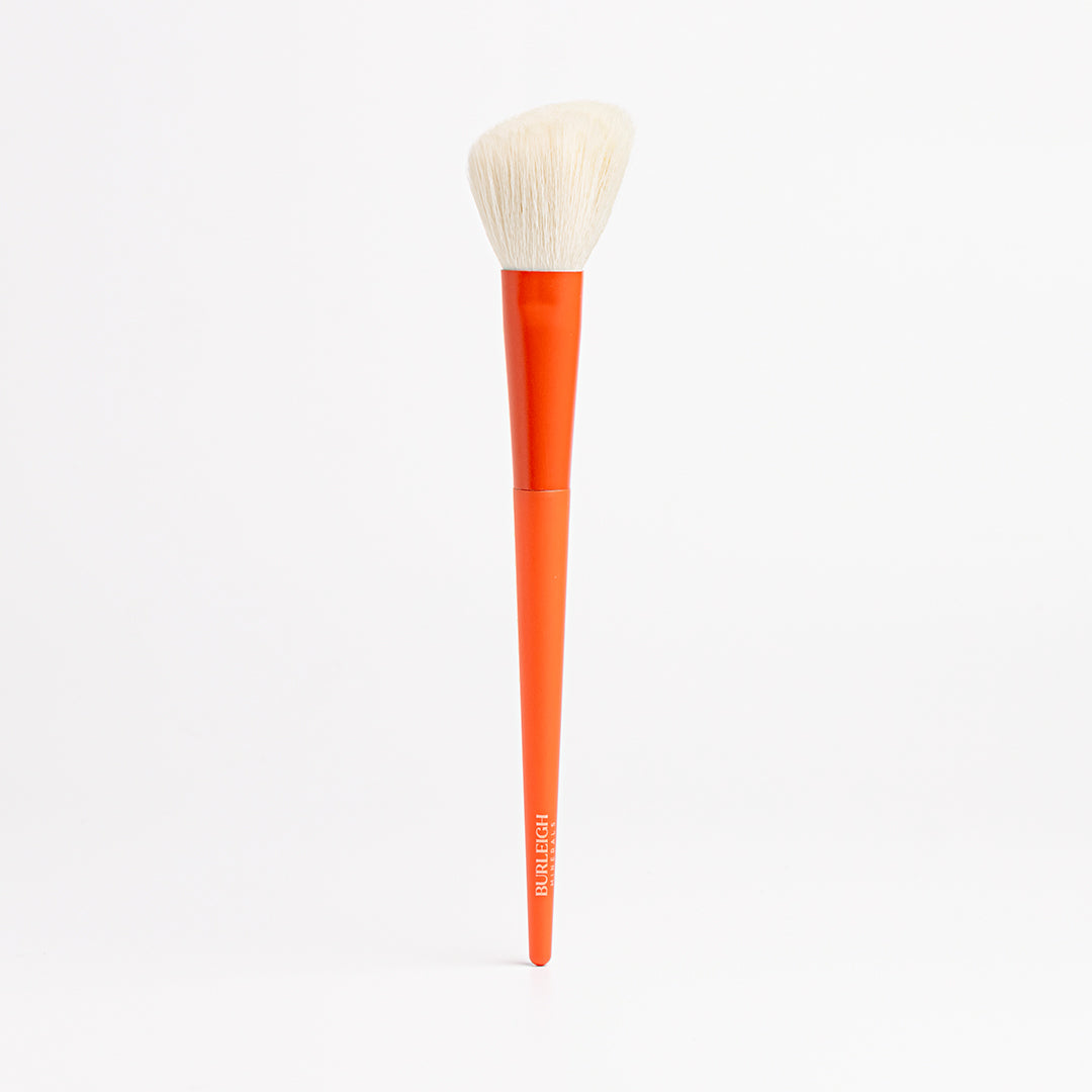 Contour Blush vegan makeup Brush with an orange handle and a tapered, angled head featuring  white bristles for precise application of contour, bronzer and blush. 