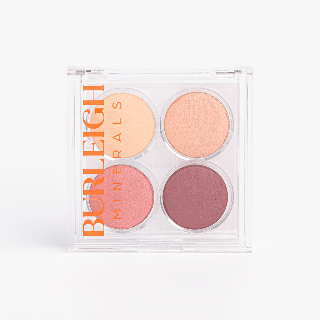 No-tox, mini eye shadow palette  featuring four rosey shades in clear casing, photographed against a white background