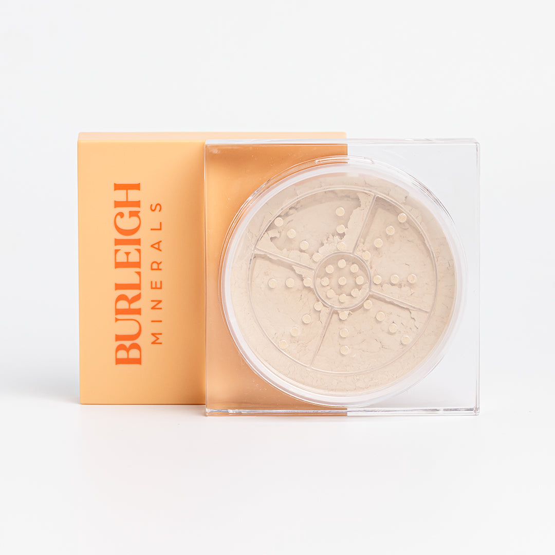 Clear container of mineral foundation powder in the 110 pearl with a pastel orange lid, photographed against a white background.