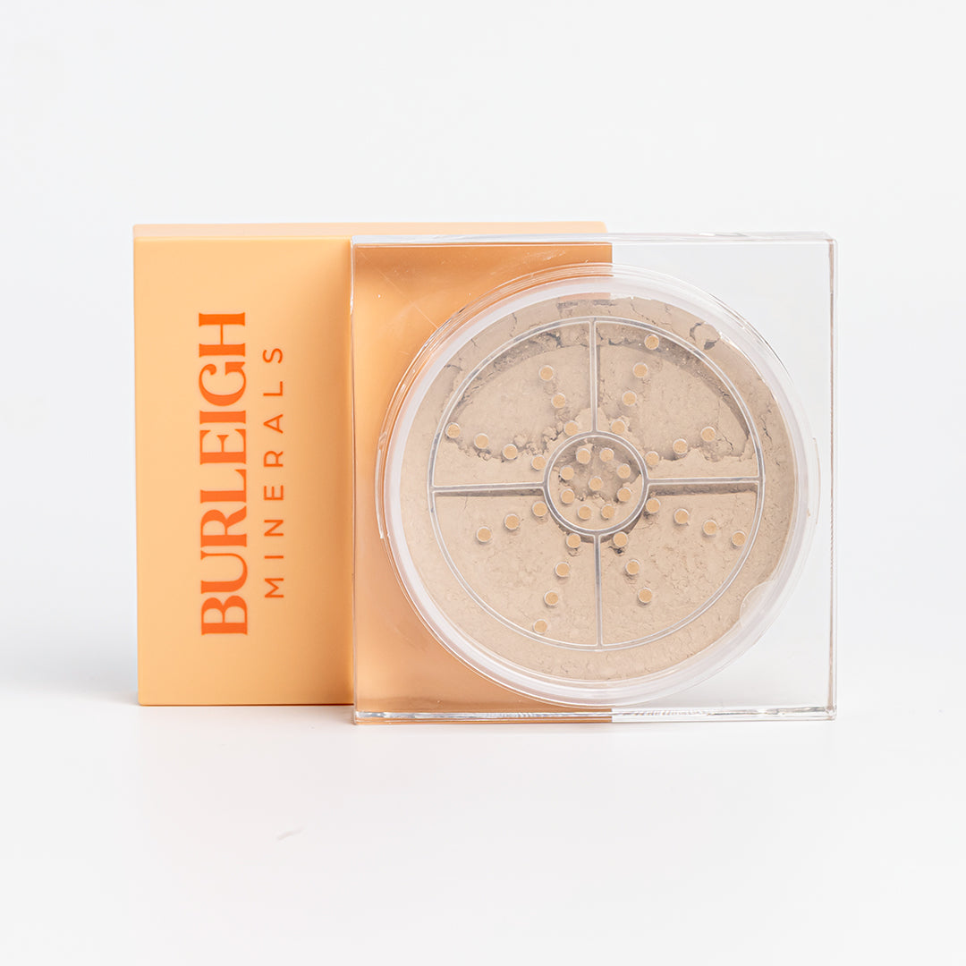 Clear container of mineral foundation powder in the 210 sand dune with a pastel orange lid, photographed against a white background.
